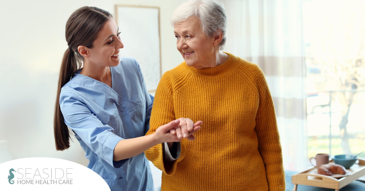 A caregiver helps a client get around, demonstrating one of the job duties of a caregiver.