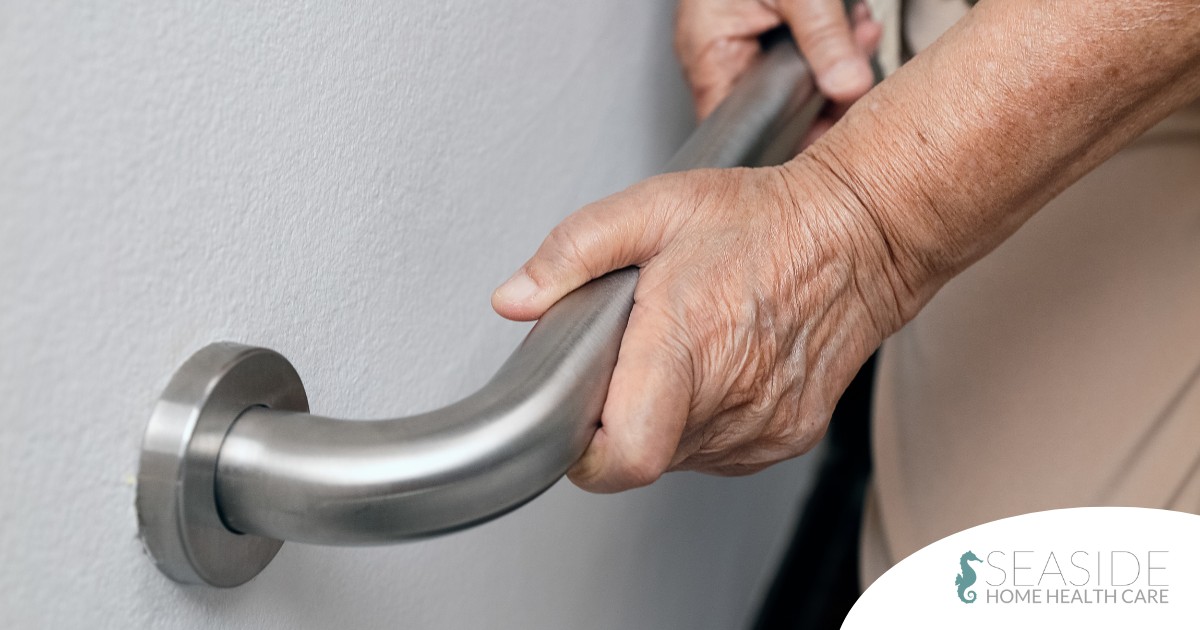 An older adult uses a grab bar representing one of the home modifications that is helpful for fall prevention for elderly adults.