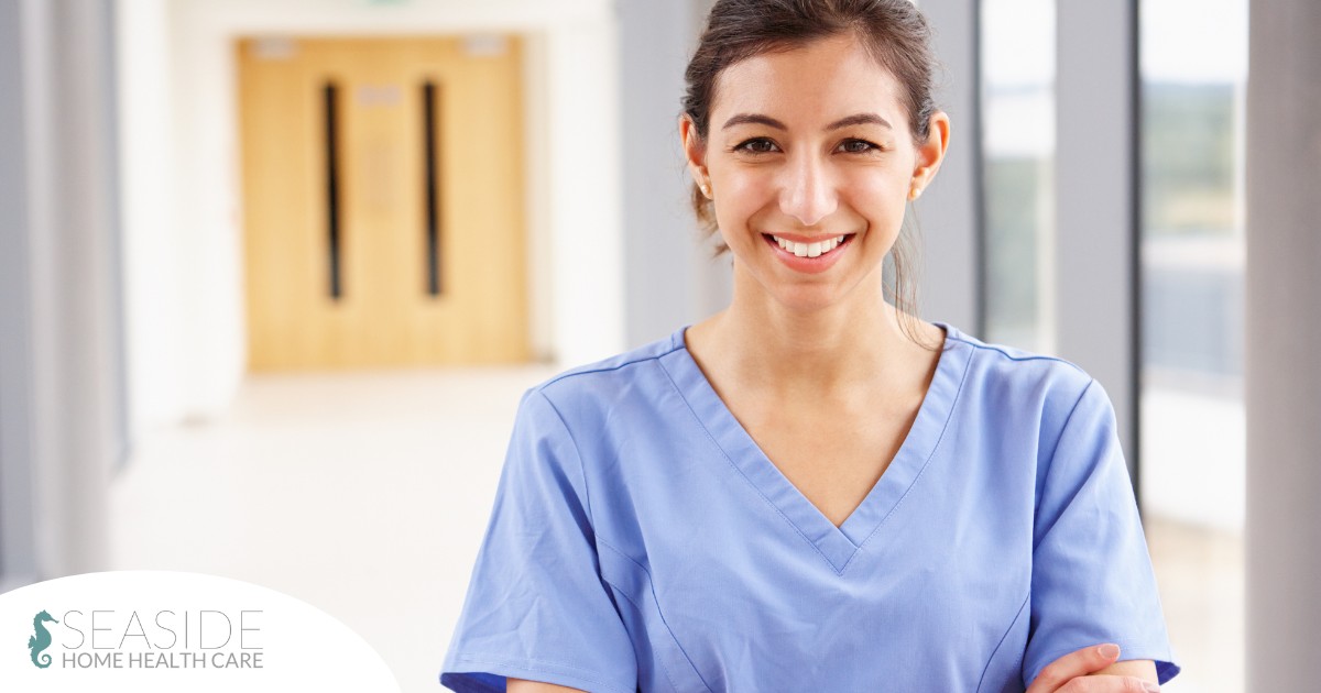 A woman in scrubs smiles, representing the good results that can come when caregivers branch out to become CNAs.